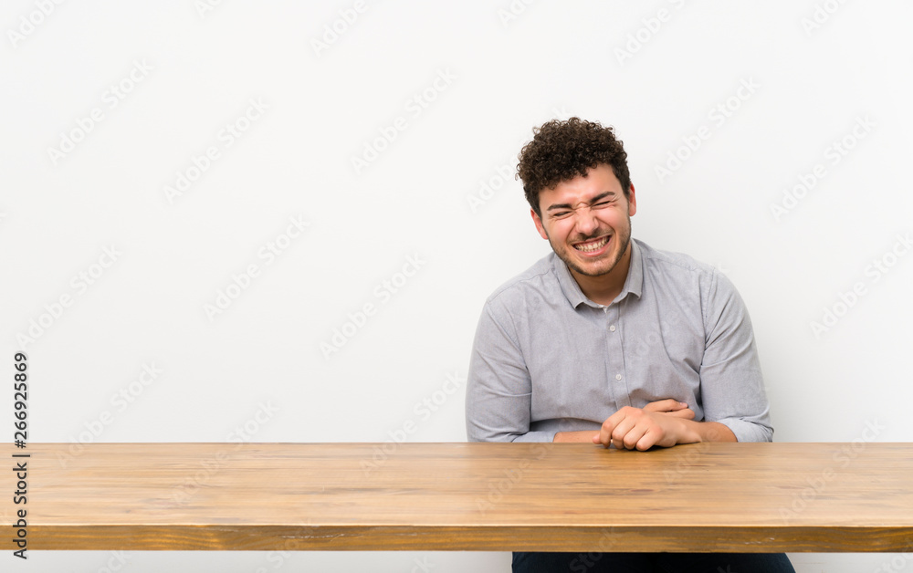 Young man with a table smiling a lot Young man with a table smiling a lot
