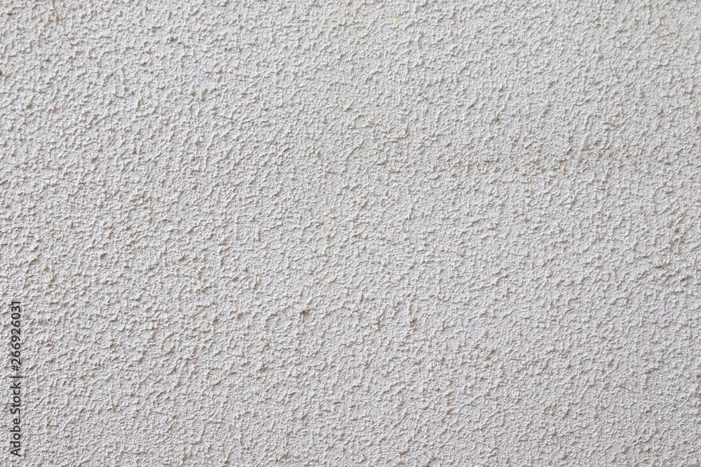 Light textured plaster on the wall. The wall is rough without seams modern decor cream. Light textured plaster on the wall. The wall is rough without seams modern decor cream.