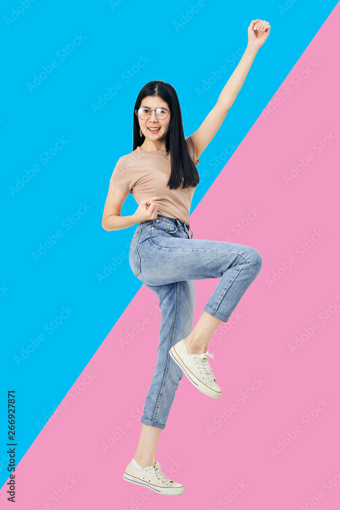 Asian woman jumping celebrating success Asian woman jumping celebrating success