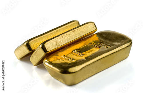 Three cast gold bars, the typical form of bullion gold bullion. Isolated on a white background. Selective focus.