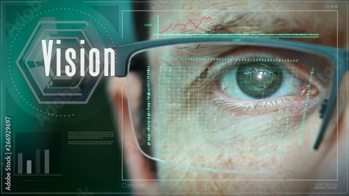 A close up of a businessman eye controlling a futuristic computer system with a Vision concept.