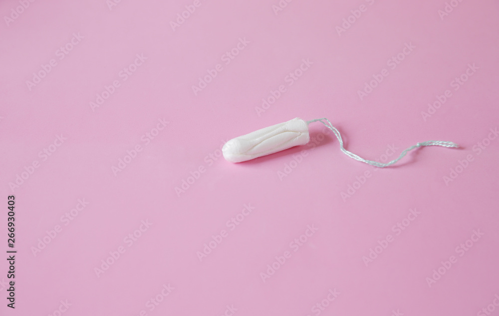 Clean white cotton tampon on pink background. Isolated. Copy space. Menstruation. Feminine Hygiene in periods, beauty treatment. Flat lay. Clean white cotton tampon on pink background. Isolated. Copy space. Menstruation. Feminine Hygiene in periods, beauty treatment. Flat lay.