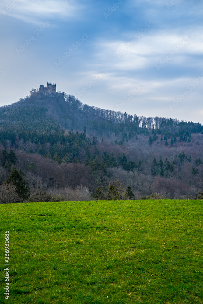 Germany, Famous ancient hohenzollern castle on top of mountain in swabian jura nature landscape