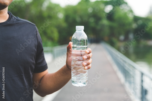 Man holding bottle of water photo