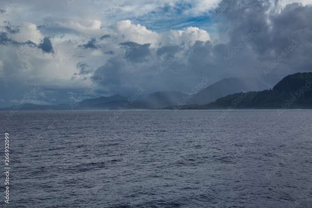 wide shot of ocean with island mountains in the distance
