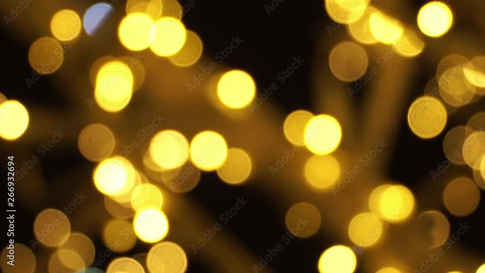 Abstract blurred golden and white bokeh light garland background at night. Christmas and New Year holidays background Abstract blurred golden and white bokeh light garland background at night. Christmas and New Year holidays background