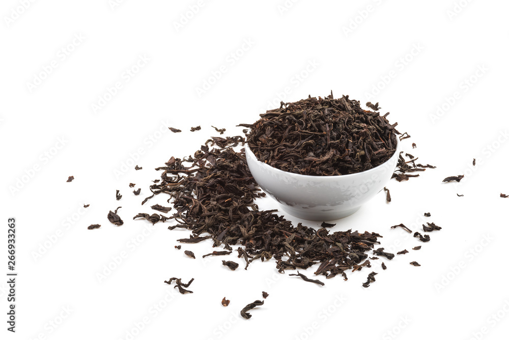Dried tea leaves in ceramic cup over white background. Dried tea leaves in ceramic cup over white background.