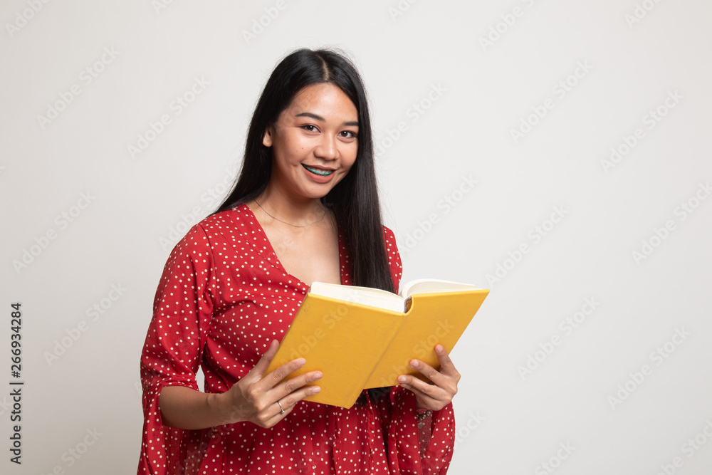 Young Asian woman with a book. Young Asian woman with a book.