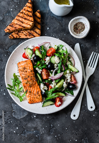 Fotografia Healthy balanced lunch - grilled red fish fillet salmon and vegetables, olives,