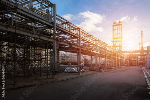 Fényképezés Pipeline and pipe rack of petroleum industrial plant with sunset sky background