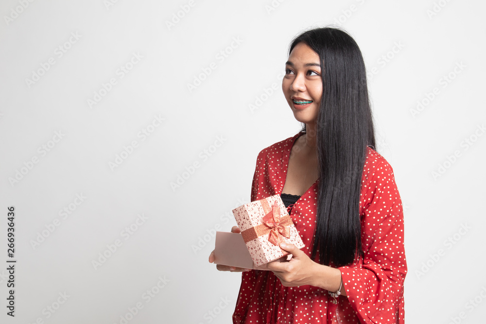 Young Asian woman open a gift box. Young Asian woman open a gift box.