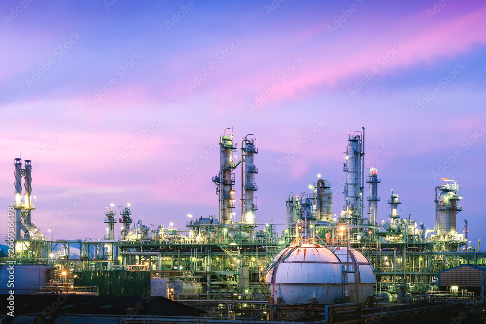 Manufacturing of petroleum industrial plant on blue sky sunset background, Glitter lighting petrochemical industry plant at twilight
