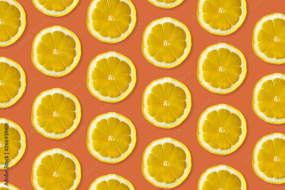 Creative pattern made of lemon. top view of fruit fresh limes slices on orange & yellow colorful background. Creative pattern made of lemon. top view of fruit fresh limes slices on orange & yellow colorful background.