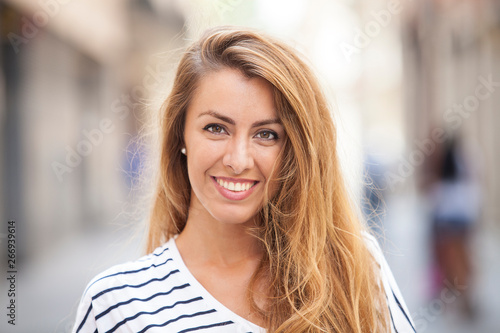 Smiling beautiful woman looking at the camera. Outdoor
