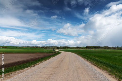Gravel rural road in countryside.