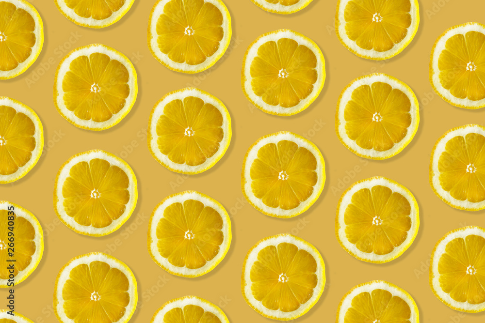 Creative pattern made of lemon. top view of fruit fresh limes slices on orange & yellow colorful background. Creative pattern made of lemon. top view of fruit fresh limes slices on orange & yellow colorful background.
