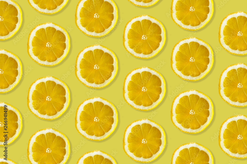 Creative pattern made of lemon. top view of fruit fresh limes slices on orange & yellow colorful background. Creative pattern made of lemon. top view of fruit fresh limes slices on orange & yellow colorful background.