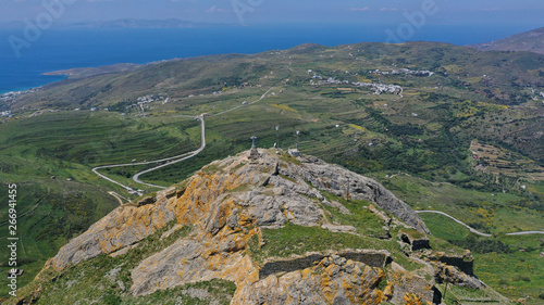 Aerial drone photo of iconic Venetian Monastery of Sacred heart Pilgrimage at the bottom of mountain and castle of Exomvourgo or Exombourgo, Tinos island, Cyclades, Greece photo