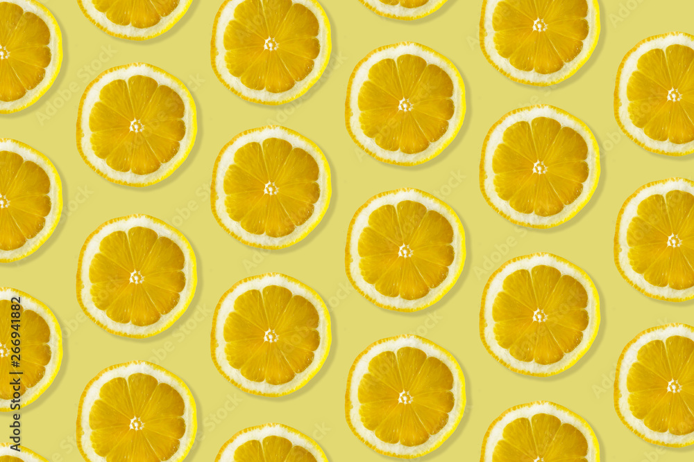 Creative pattern made of lemon. top view of fruit fresh limes slices on orange & yellow colorful background. Creative pattern made of lemon. top view of fruit fresh limes slices on orange & yellow colorful background.