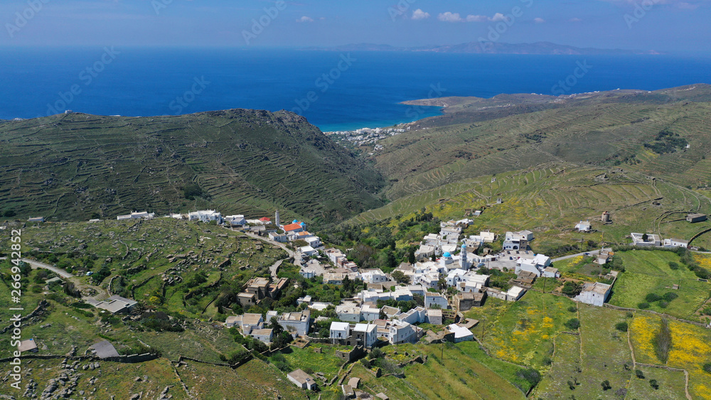 Aerial drone spring photo of picturesque beautiful twin villages of Ktikados and Hatzirados with traditional architecture overlooking seaside village of Kionia, Tinos island, Cyclades, Greece