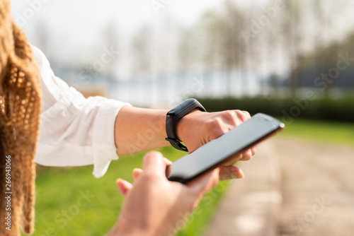 woman using smart watch and cellphone