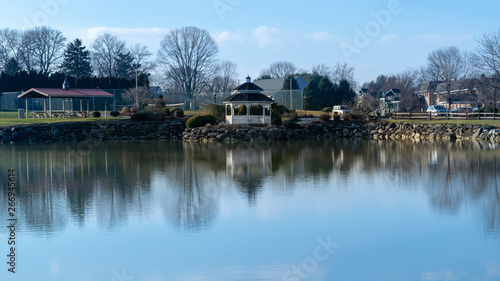 A small pond with a gazebo reflecting in the water, on a beautiful, calm and quiet day, Lancaster County, PA