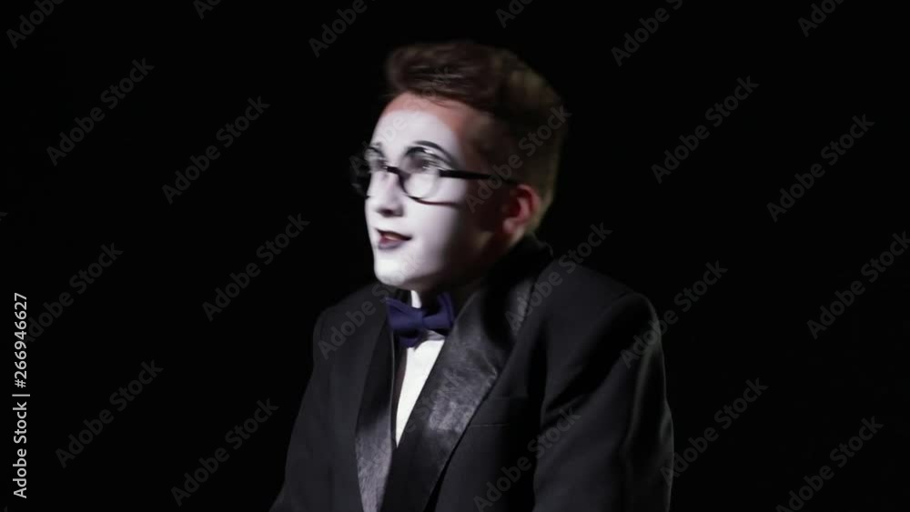 mime in a tuxedo with bowie shakes and then suddenly stops. slow motion mime in a tuxedo with bowie shakes and then suddenly stops. slow motion