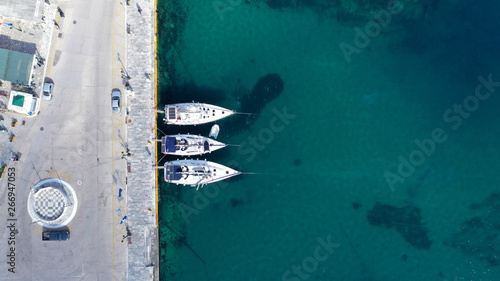 Aerial drone photo of iconic main town and port of Tinos island featuring monastery of Panagia Megalochari (Virgin Mary), Cyclades, Greece © aerial-drone