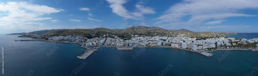 Aerial drone photo of iconic main town and port of Tinos island featuring monastery of Panagia Megalochari (Virgin Mary), Cyclades, Greece