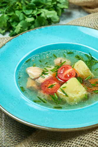 Cuadro en lienzo Red fish soup in a blue plate