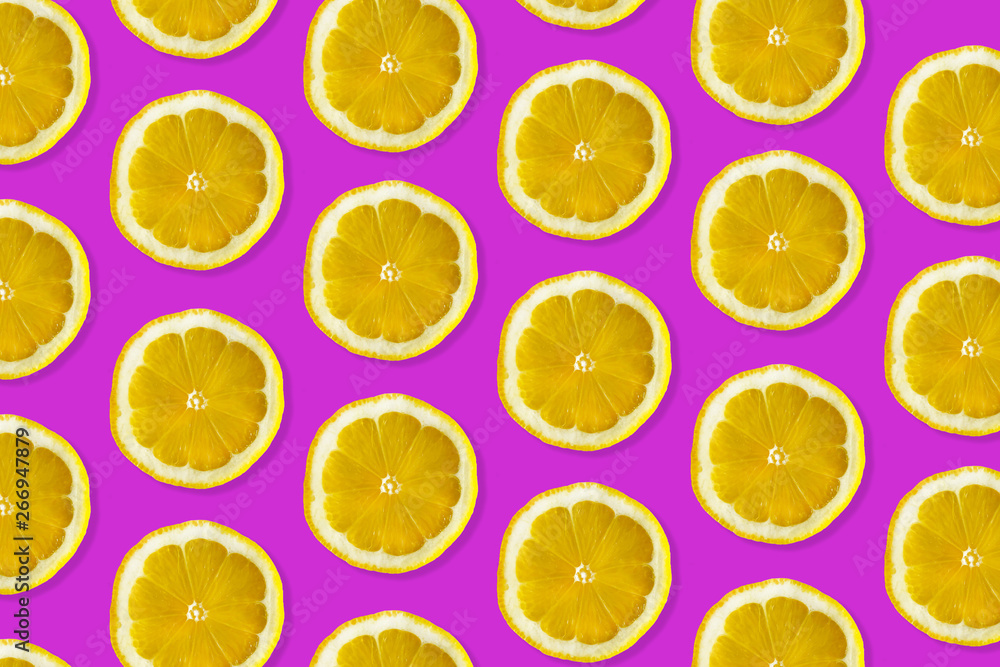 Creative pattern made of lemon. top view of fruit fresh limes slices on pink colorful background. 