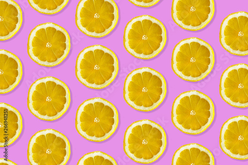 Creative pattern made of lemon. top view of fruit fresh limes slices on pink colorful background. 