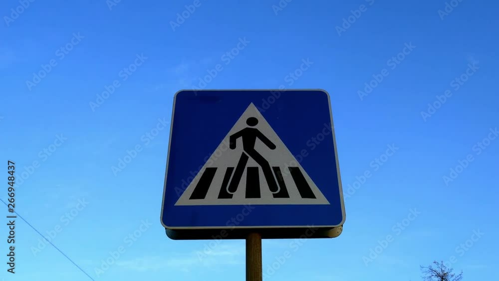 Blue pedestrian crossing sign on a clear summers day Blue pedestrian crossing sign on a clear summers day