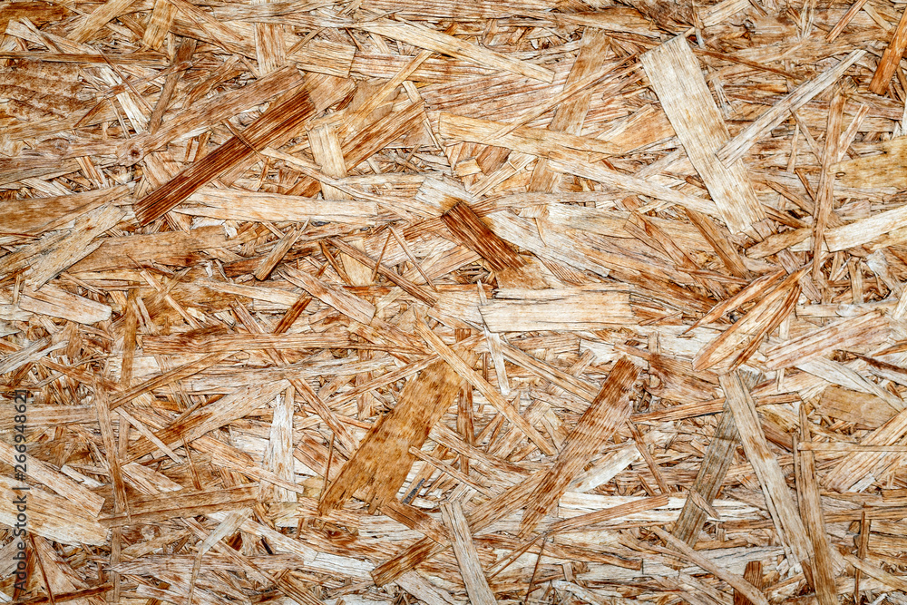 The texture of the wooden surface of pressed chips and sawdust closeup. The texture of the wooden surface of pressed chips and sawdust closeup.