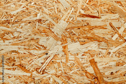 The texture of the wooden surface of pressed chips and sawdust closeup. photo
