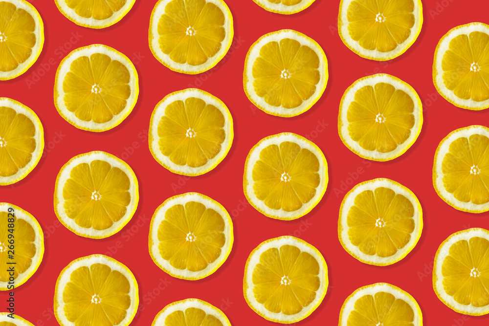 Creative pattern made of lemon. top view of fruit fresh limes slices on red colorful background. Creative pattern made of lemon. top view of fruit fresh limes slices on red colorful background.