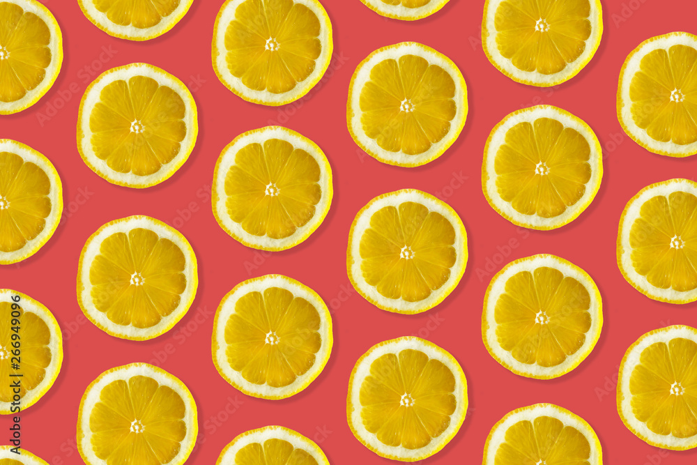 Creative pattern made of lemon. top view of fruit fresh limes slices on red colorful background. 