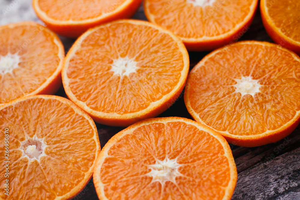 Fresh sliced oranges on wooden table. Halves of fruit. Fresh sliced oranges on wooden table. Halves of fruit.