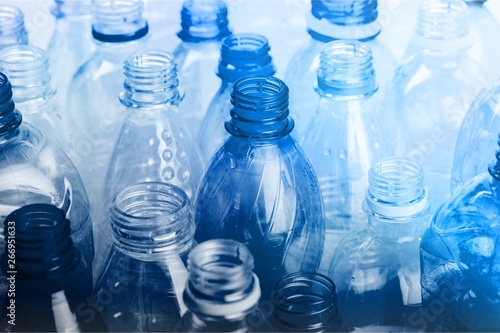 Plastic bottles of water isolated on background photo