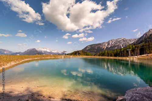The magical panorama of the alpine lake and the Bavarian mountains, unusually clear, crystalline water reflect the colors of the sky and the forest © Auslander