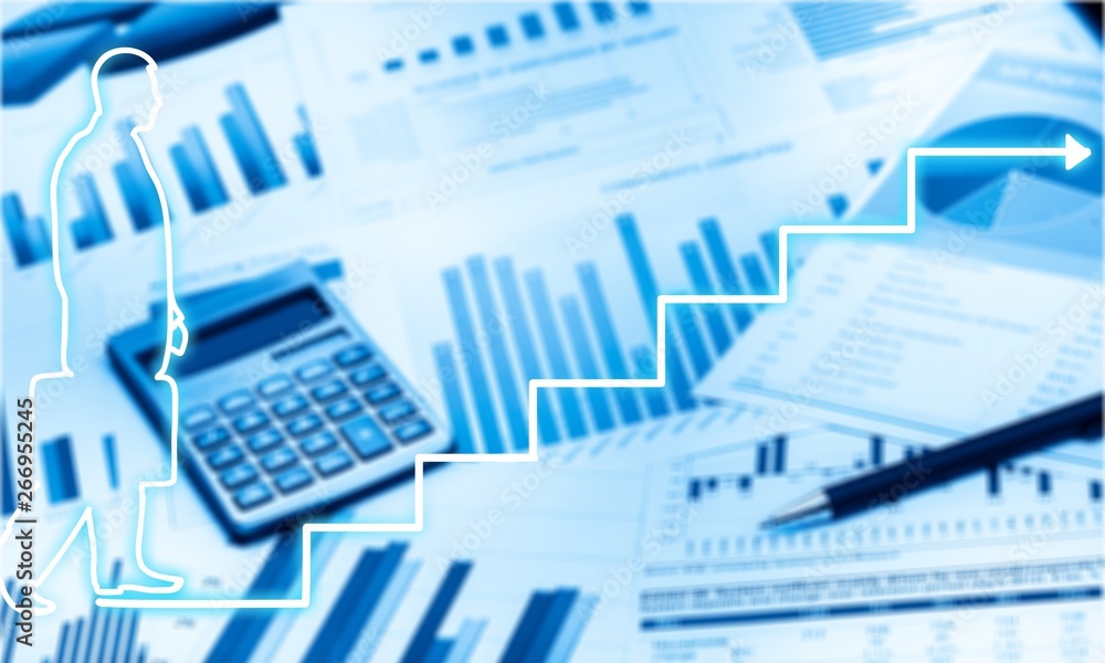 Obraz premium Pen and Calculator on Business Graphs and Charts