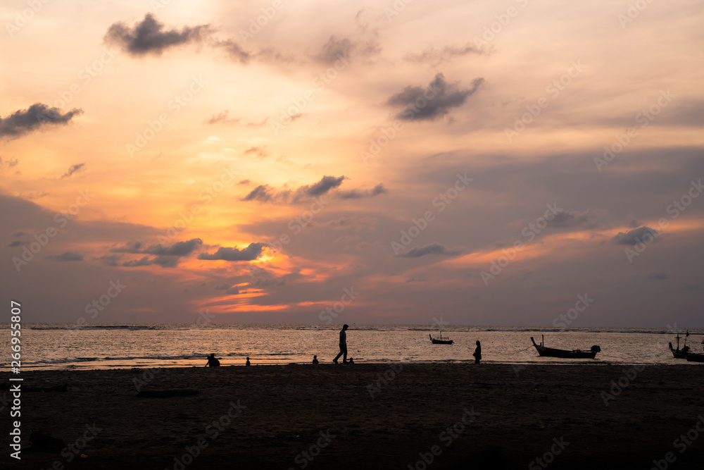 Background sky sunset,Silhouette Thai boat love travel to the beach adventure,Bright in Phuket Thailand. Background sky sunset,Silhouette Thai boat love travel to the beach adventure,Bright in Phuket Thailand.