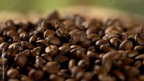 Coffee close up. Sunshine on coffee seeds. Slow mothion. Seeds of coffee fall. Dark Coffee Grains. photo