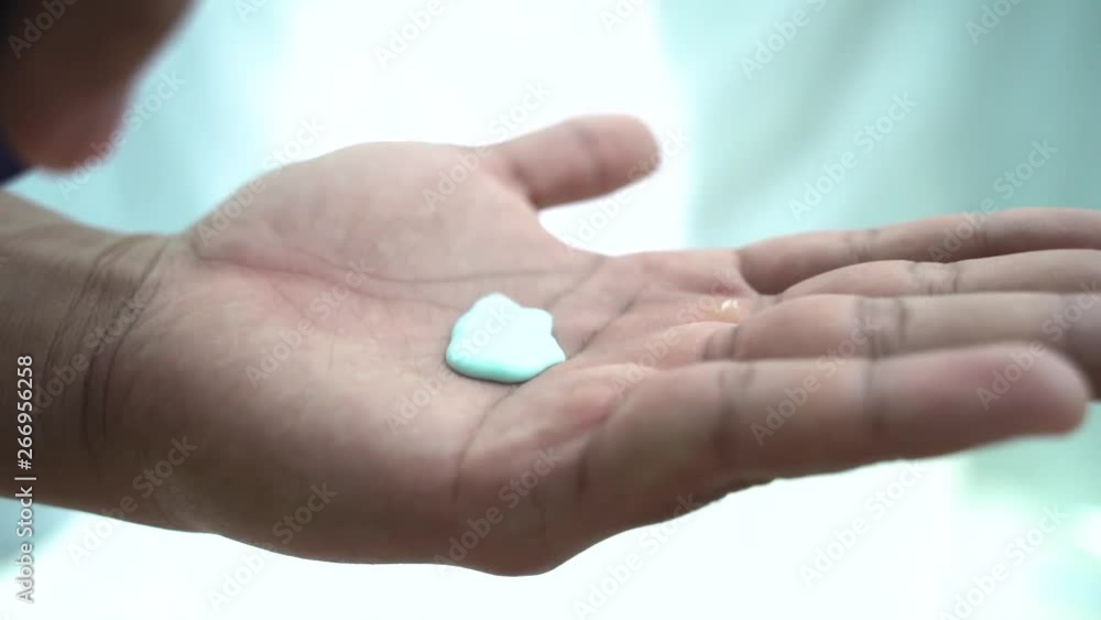 Man hands tan skin using cosmetic liquid shampoo soap close up. Man hands tan skin using cosmetic liquid shampoo soap close up.