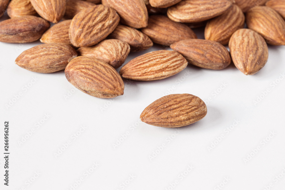 A heap of almonds isolated on white background. A heap of almonds isolated on white background.