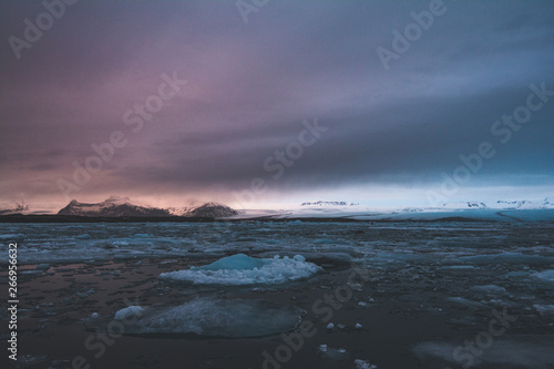 Jokulsarlon, glacier lagoon in Iceland at night with ice floating in water. Cold arctic nature landscape scenery. Ice melting.