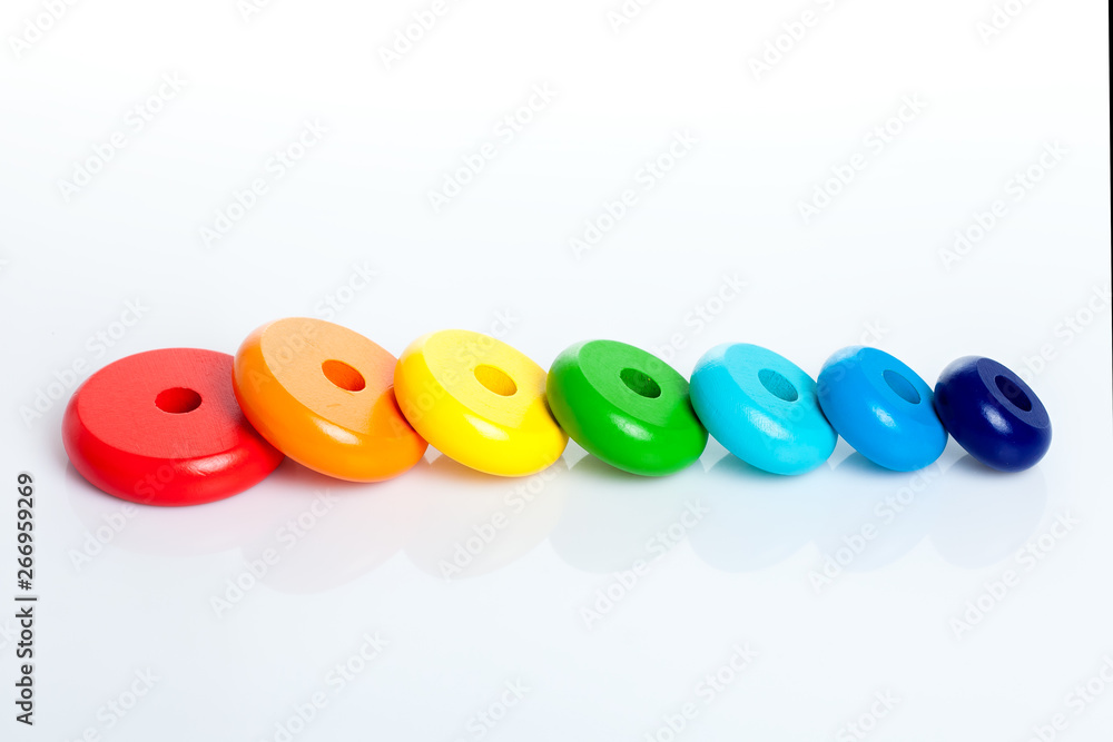 Fototapeta premium Toys for babies and toddlers to joyfully learn mechanical skills and colors lies on a white background of copy space.