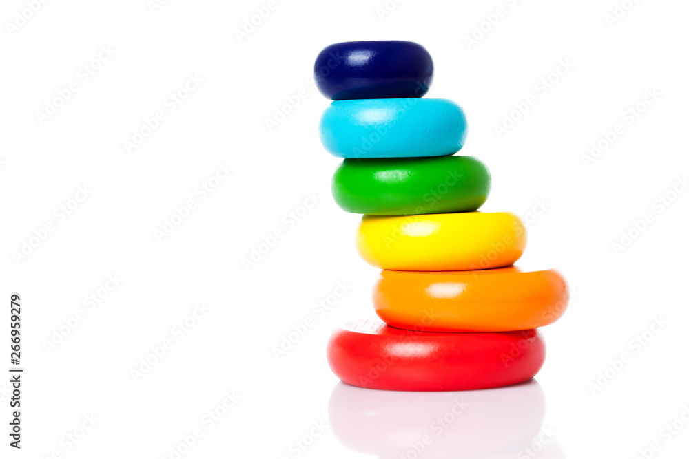 A big pyramid build from colored wooden rings of color lgbt flag isolated on a white background copy space. A big pyramid build from colored wooden rings of color lgbt flag isolated on a white background copy space.