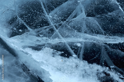 Sun rays are refracted by the transparent ice of Lake Baikal. cracks at different depths create a bizarre web