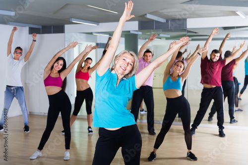 men women posing in fitness studio